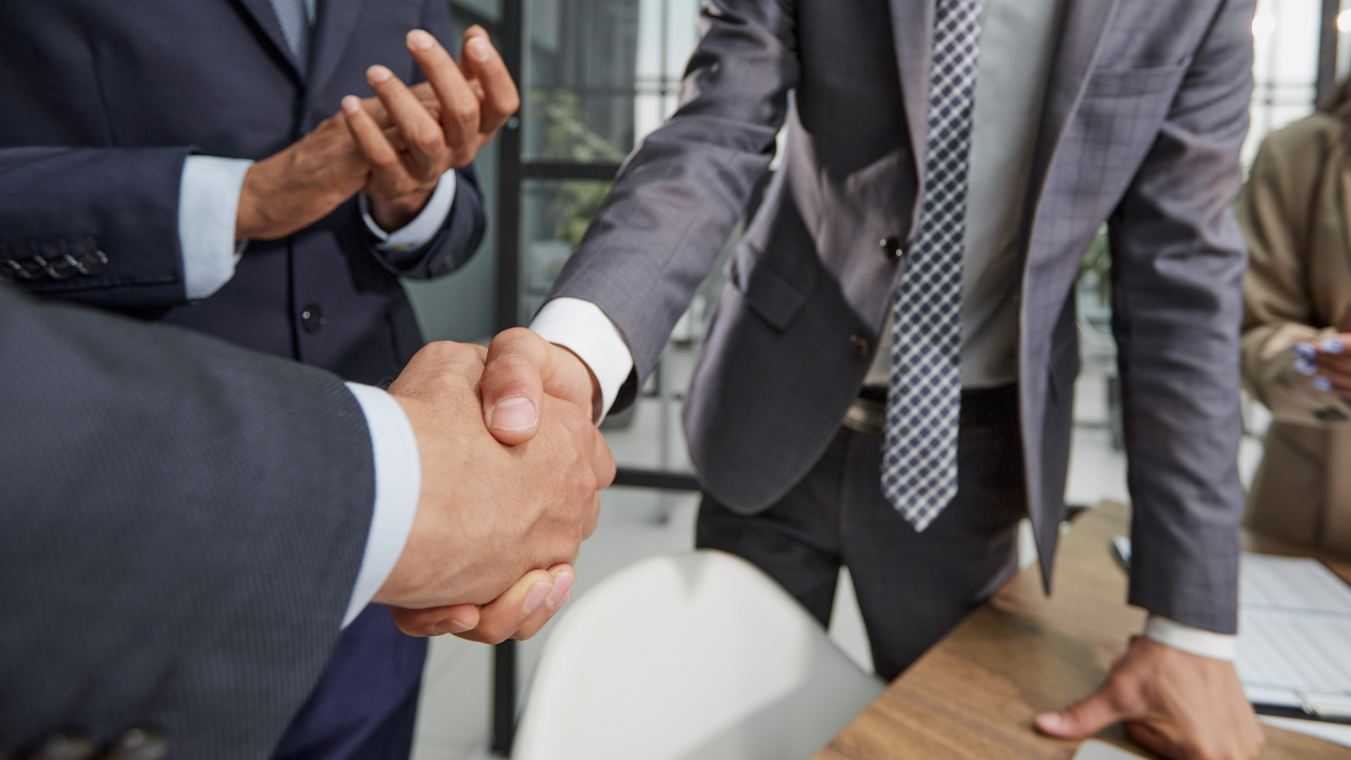 Entrepreneurs and Meritus Group advisors discussing business acquisition strategies