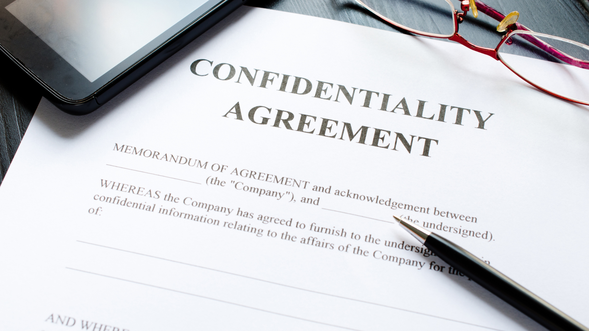 Business professionals discussing over a confidentiality agreement document