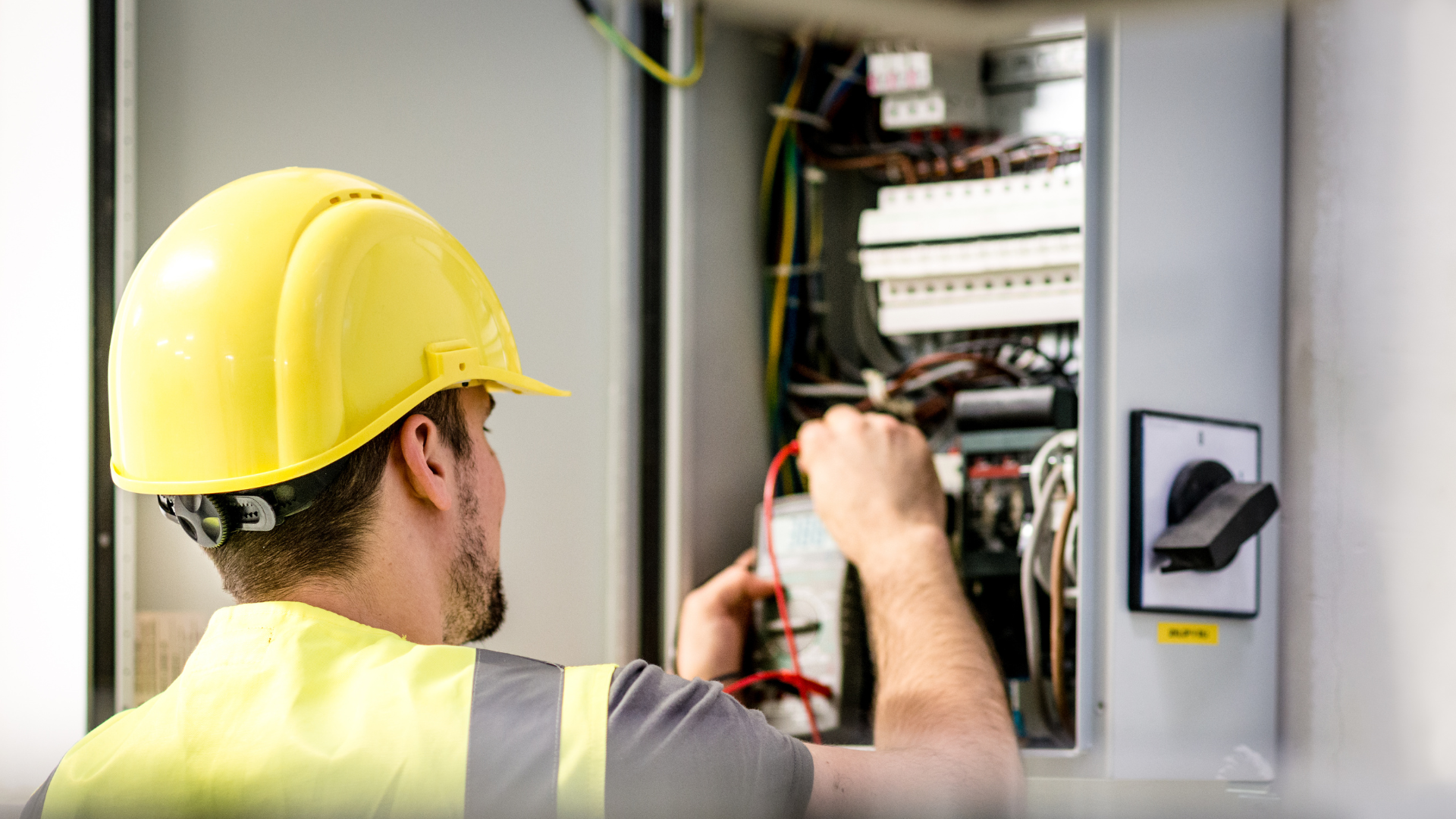 An electrician working on a modern electrical installation, symbolizing innovation in the electrical services industry