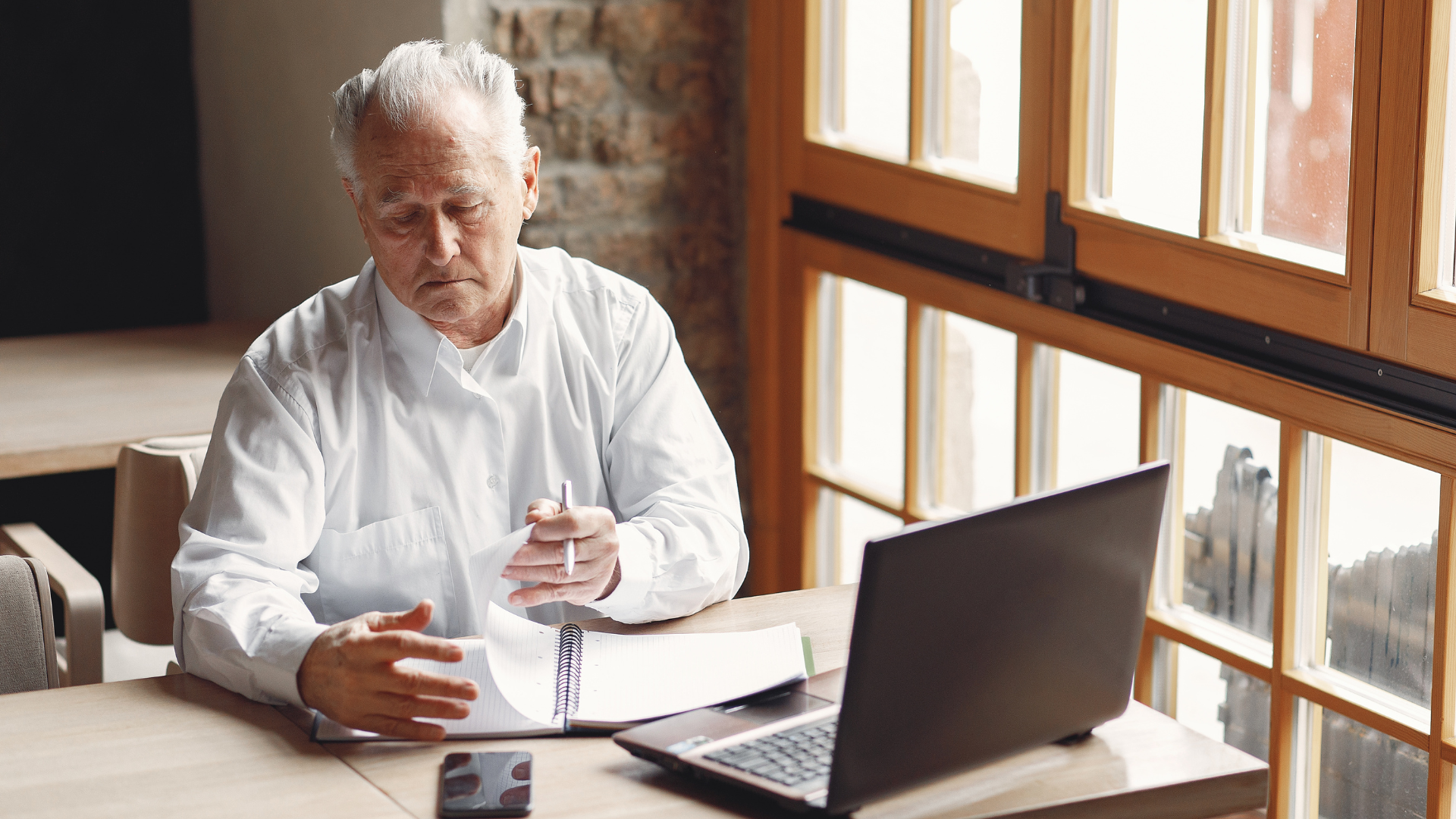 Business owner reviewing financial documents to understand the value of their business before selling.