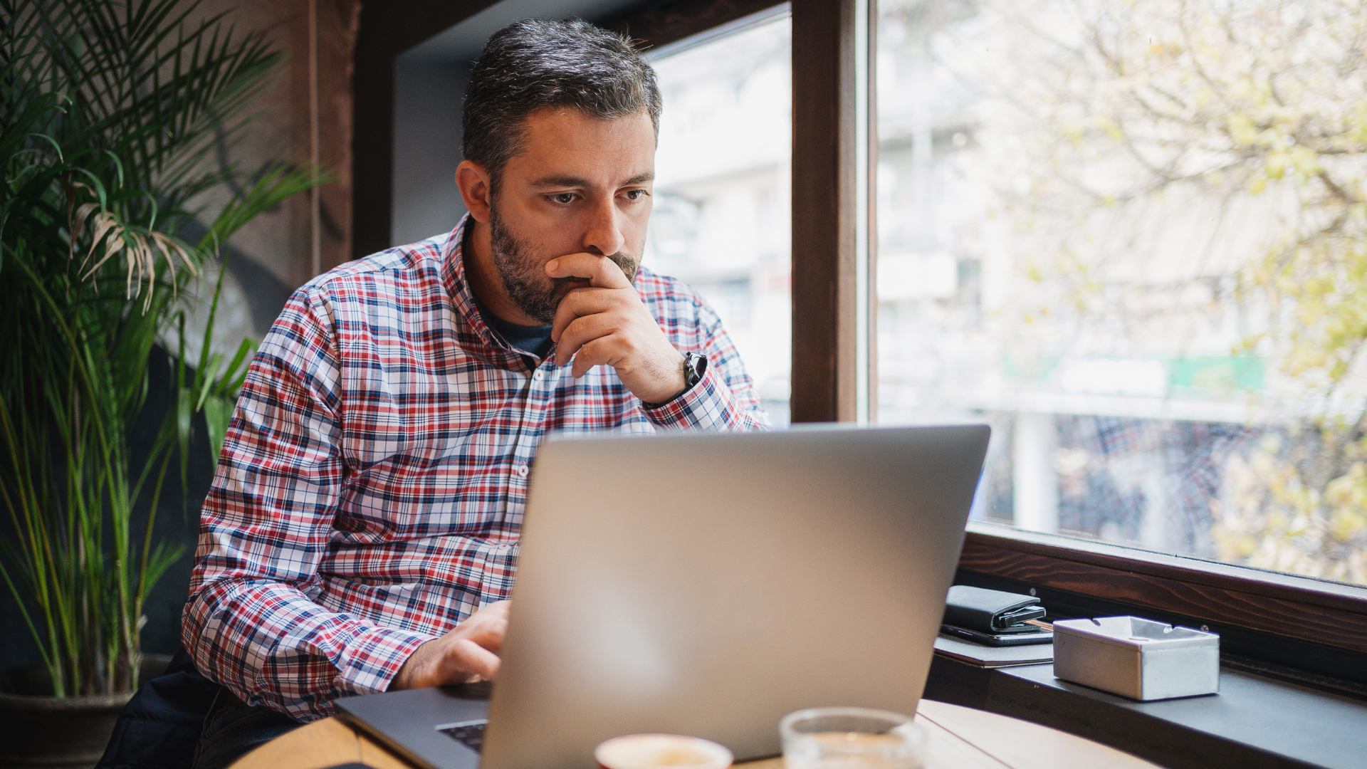Business owner planning a premium sale strategy with documents and financial charts for 2025.