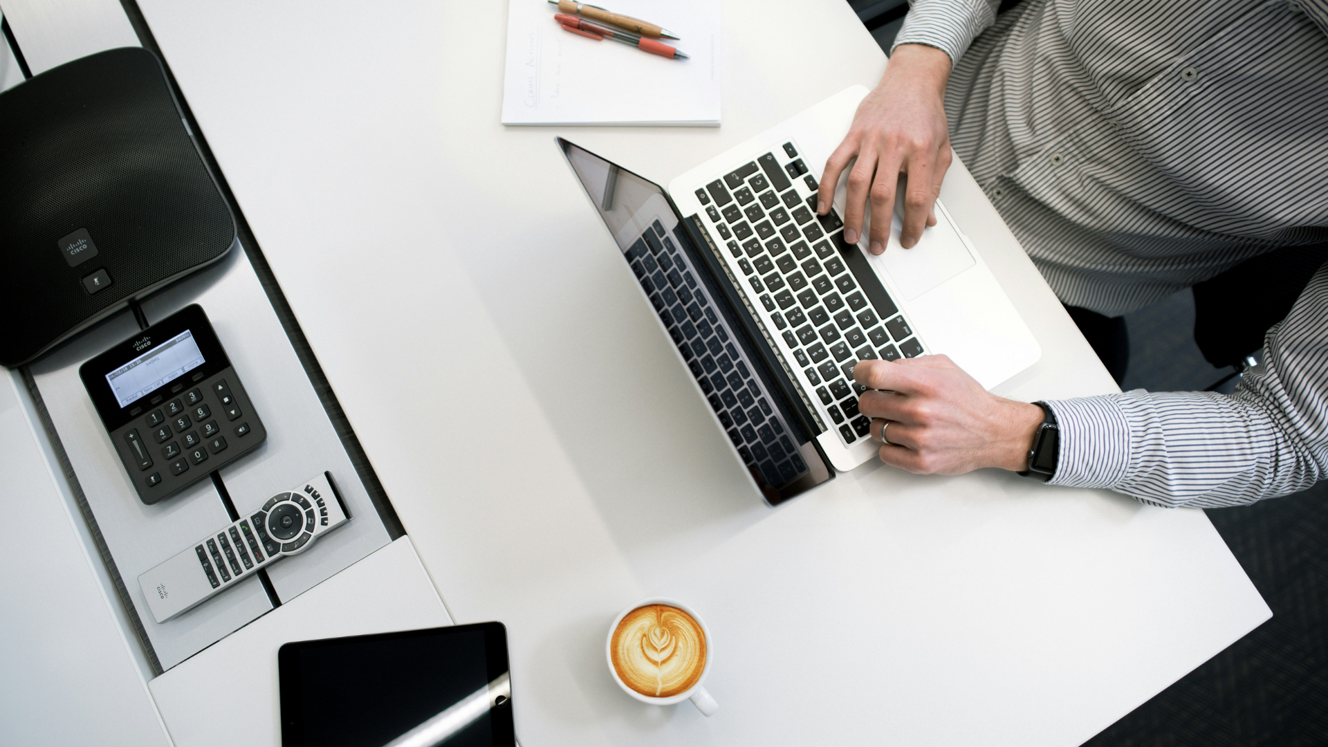 A professional business owner reviewing financial reports to determine company valuation before selling.