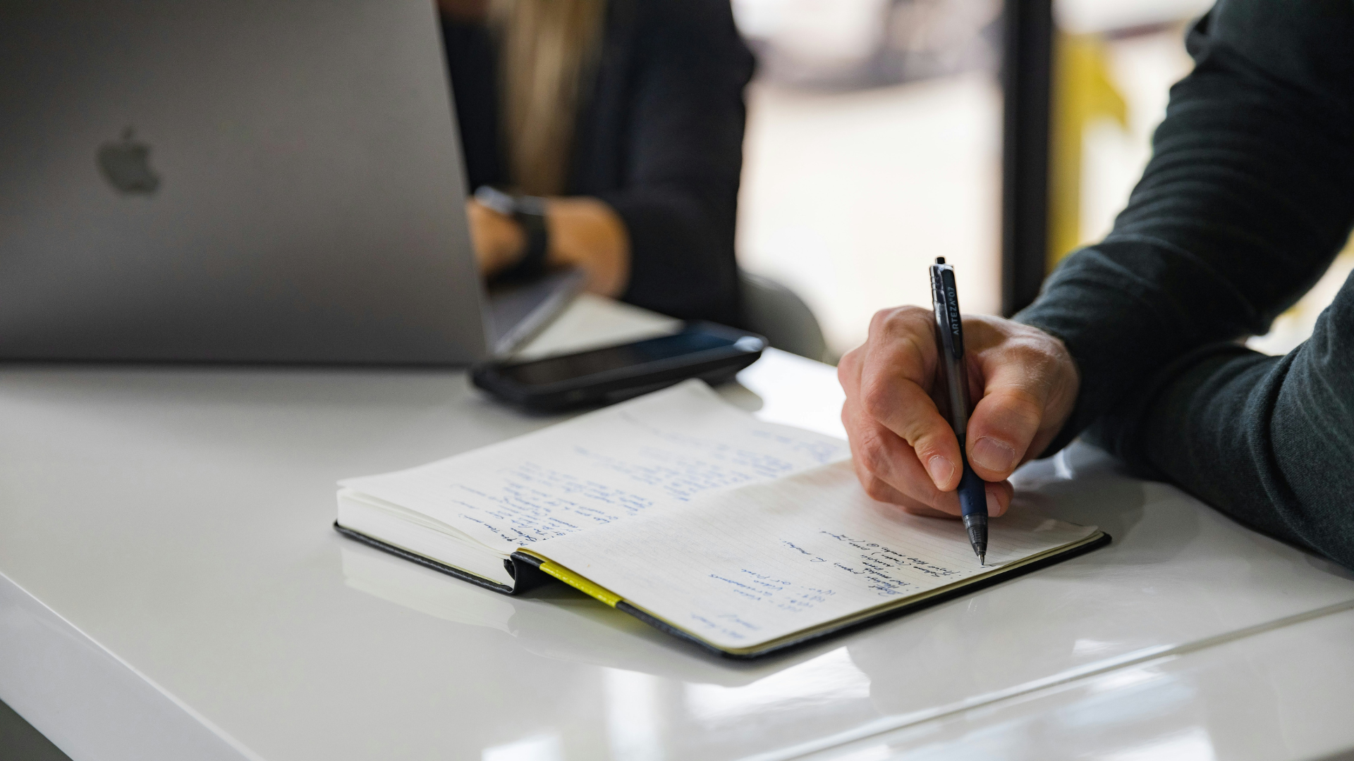 A business owner reviewing financial documents and market trends to determine the right time to sell.