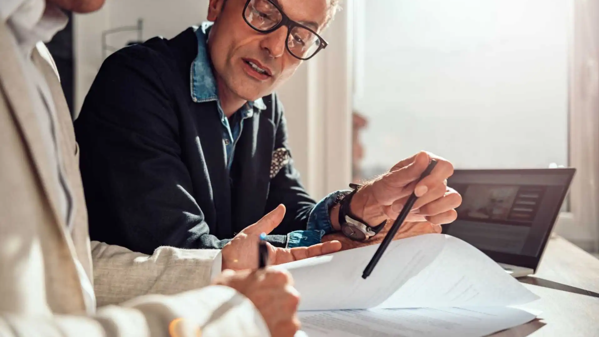 Business owner and advisor discussing asset vs. stock sale deal structure options