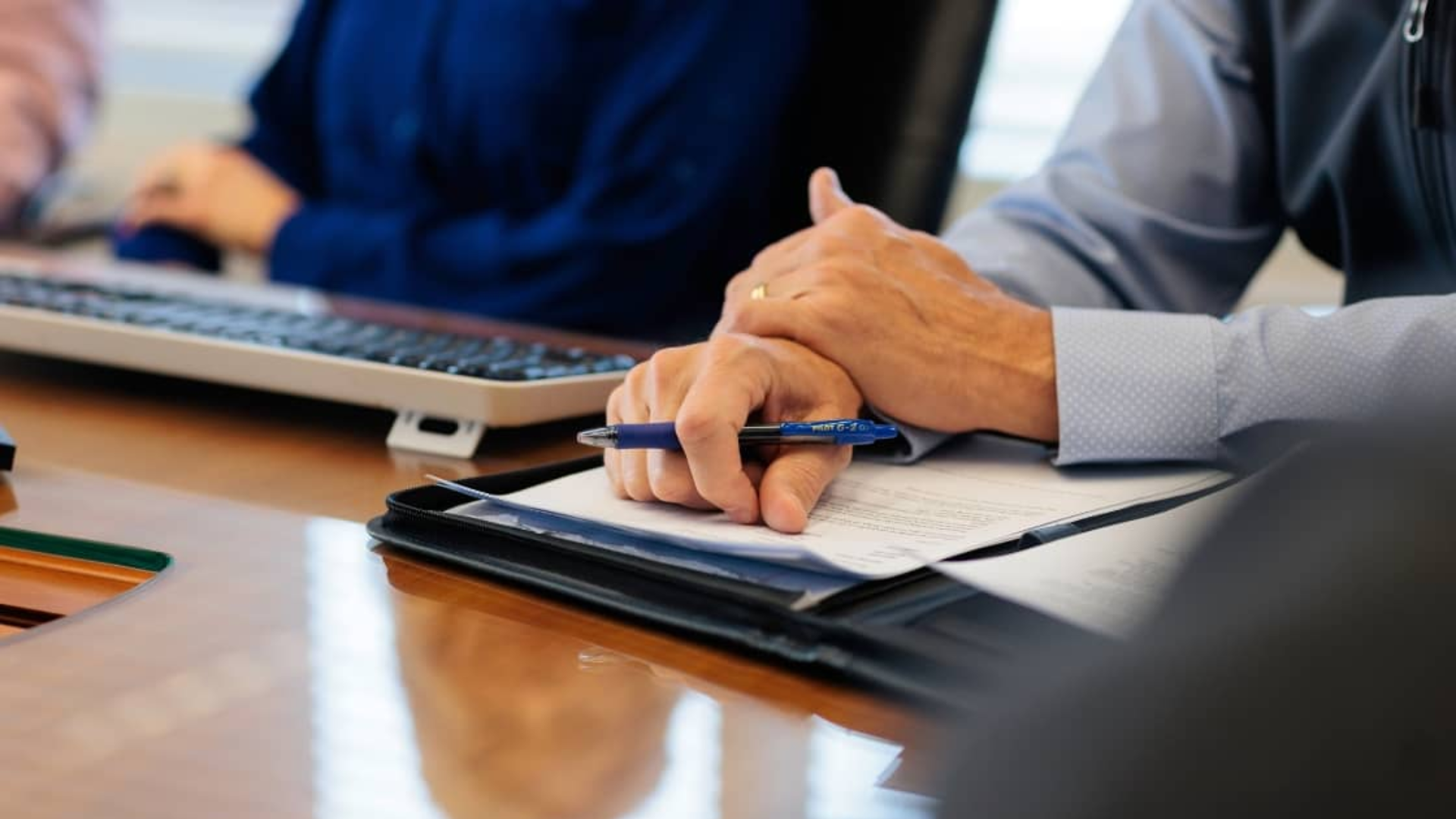 Business buyer and advisor reviewing financials and growth potential during due diligence process